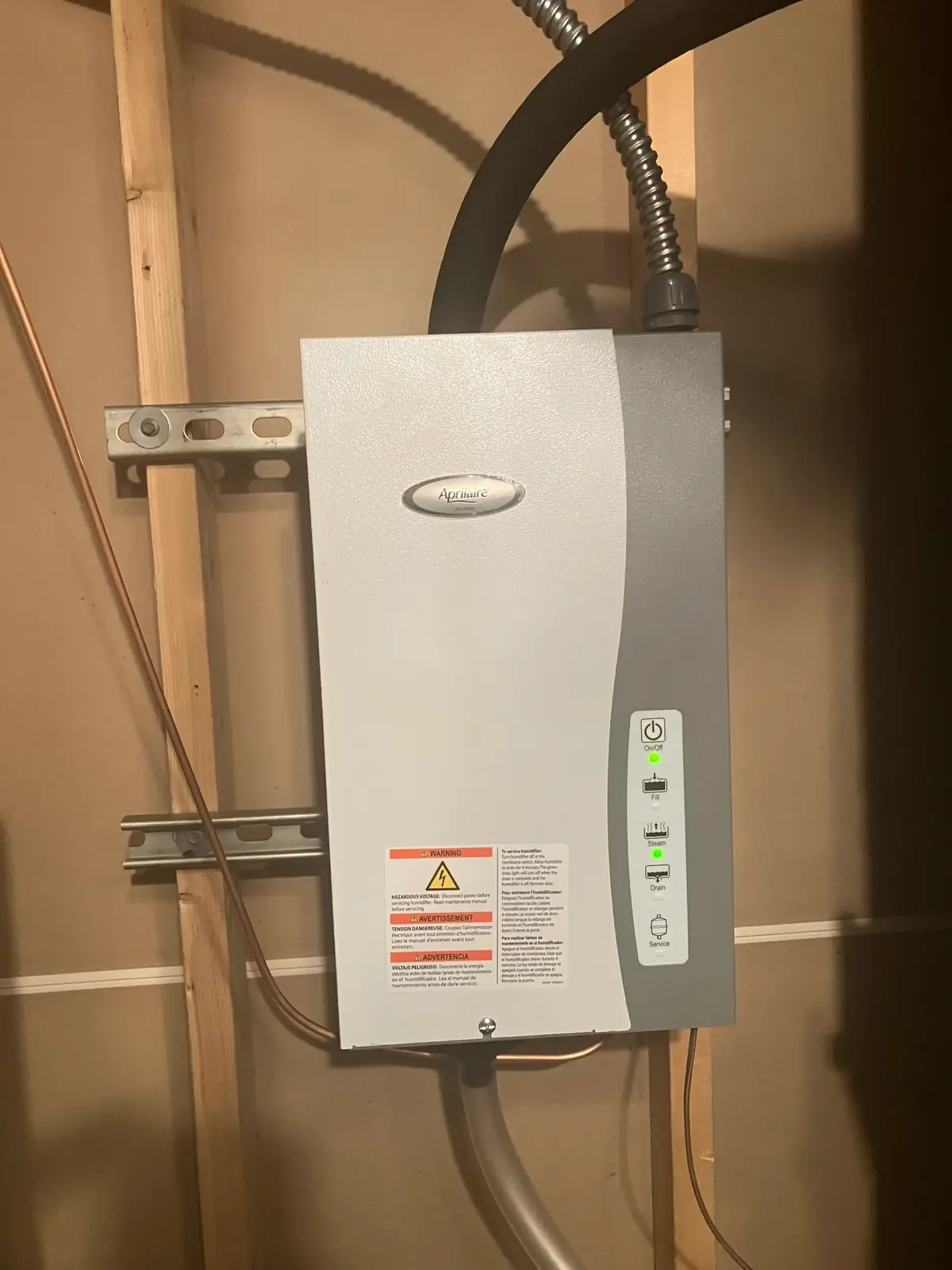Aprilaire humidifier with control panel and service indicator