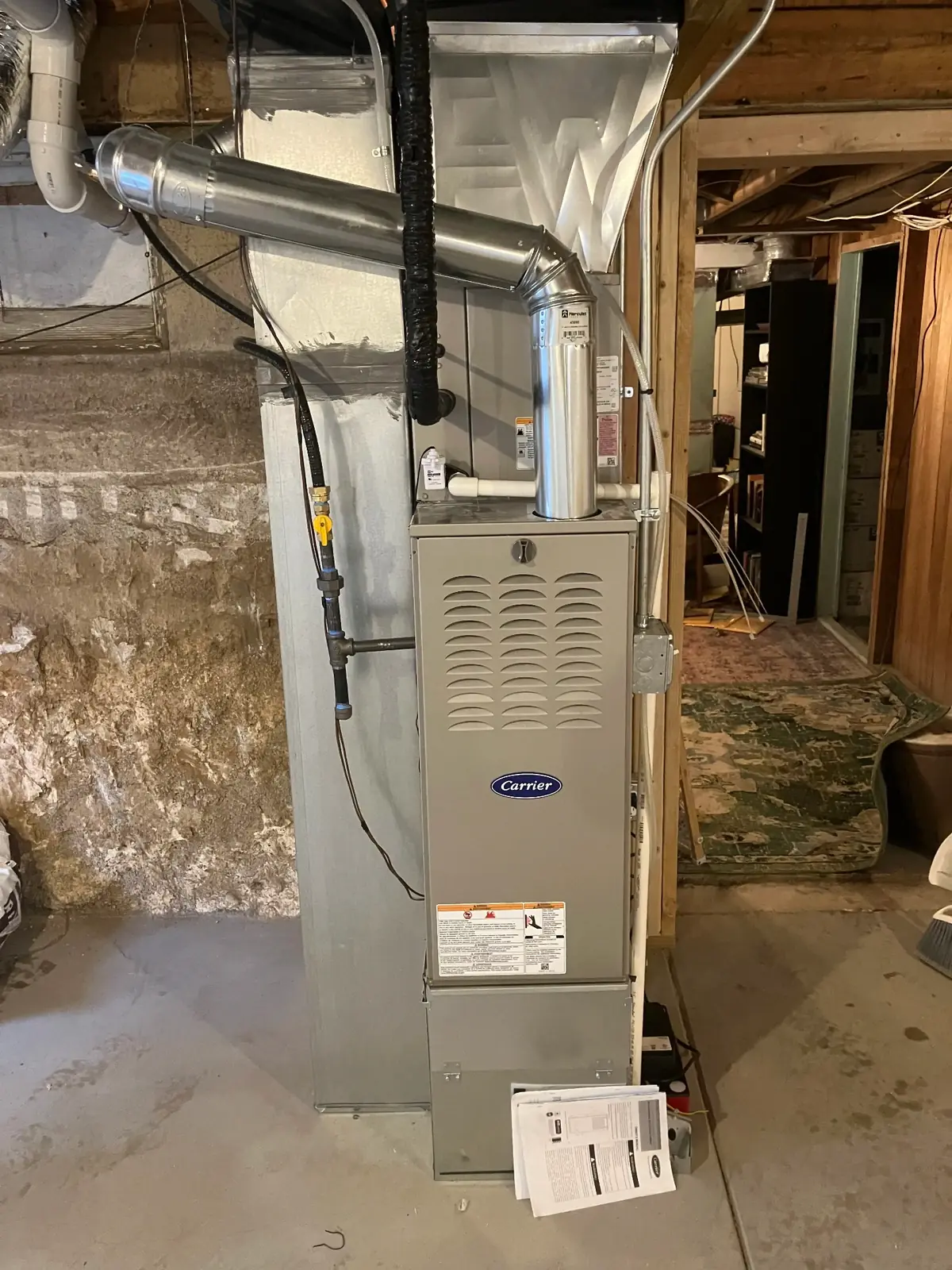 Professional furnace repair service in Greeley CO showing Carrier furnace installation and maintenance by East to West Heating and Air Conditioning technicians