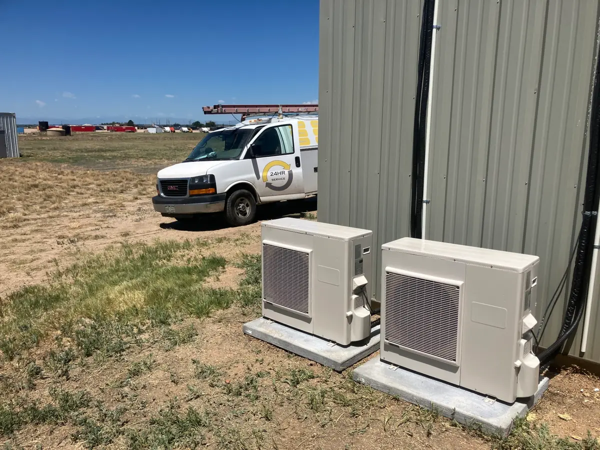 Commercial heat pump installation showing multiple outdoor units on concrete pads for business HVAC systems