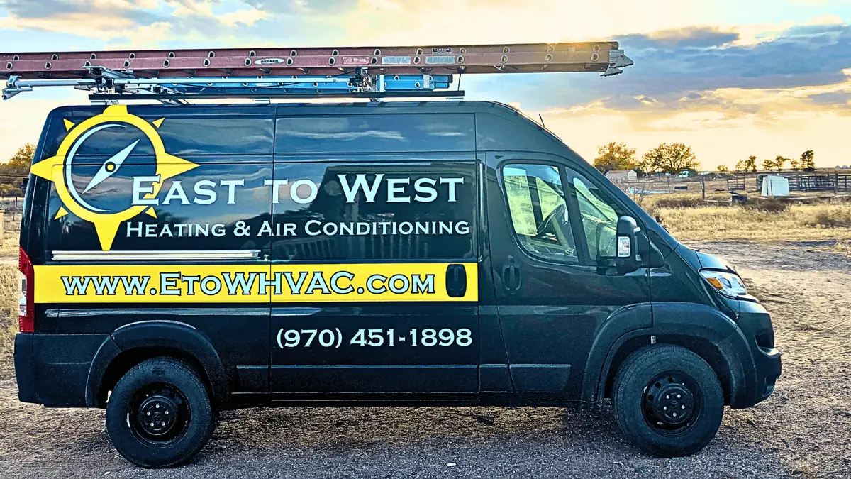 East to West Heating and Air Conditioning service van in rural Colorado setting, showcasing our service area coverage