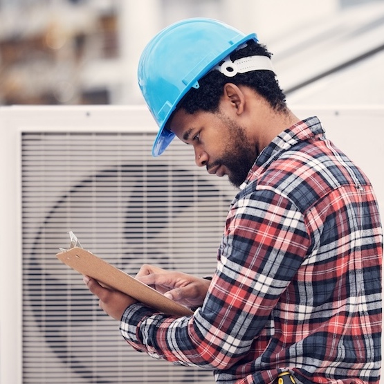 A competent HVAC technician is reviewing their checklist.